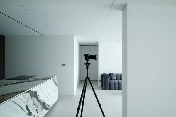 Camera on tripod in a professionally staged rental interior
