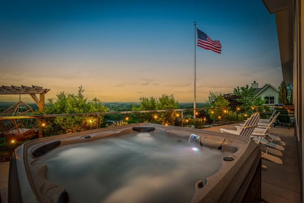 Rooftop deck with string lights at dusk — a great listing photo subject
