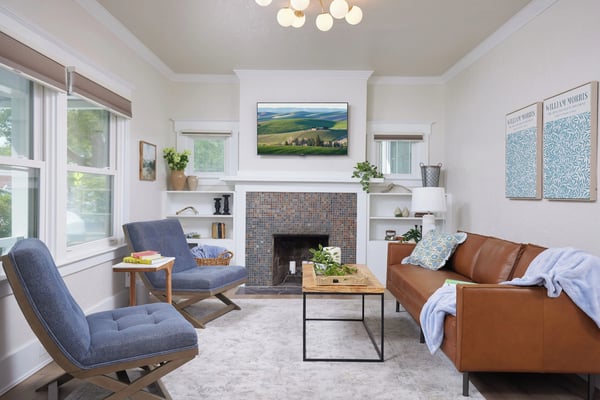 Bright living room with fireplace in Oasis Escapes rental